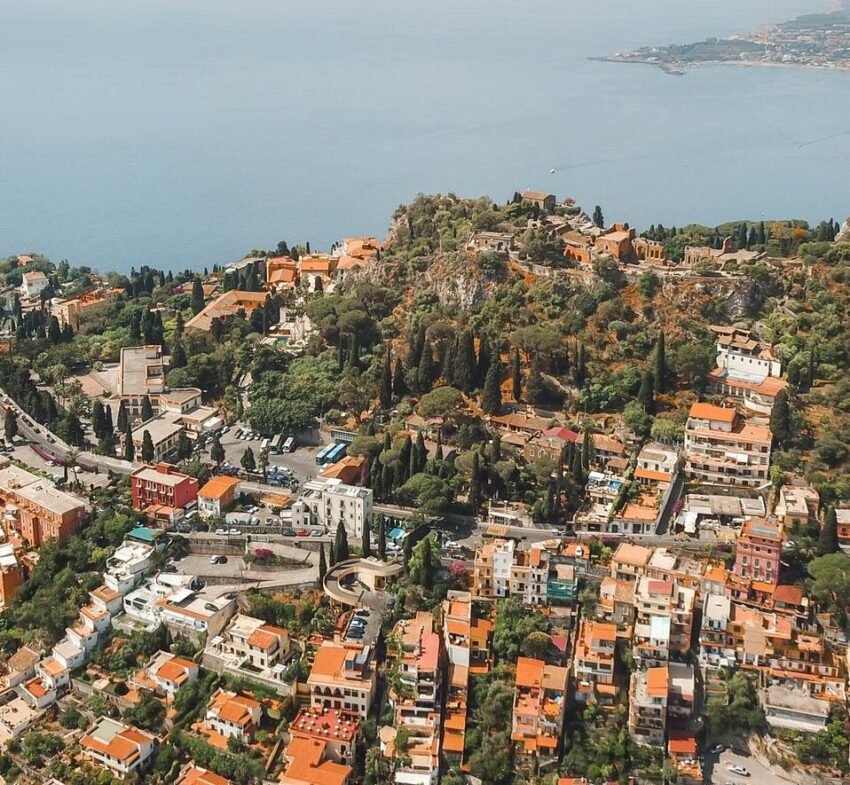 aerial photography of buildings and body of water