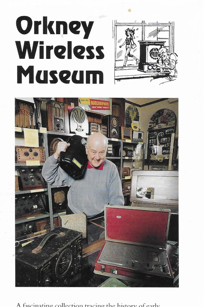 Part of a publicity leaflet for the Orkney Wireless Museum. Behind a museum volunteer are shelves packed with old radio sets.