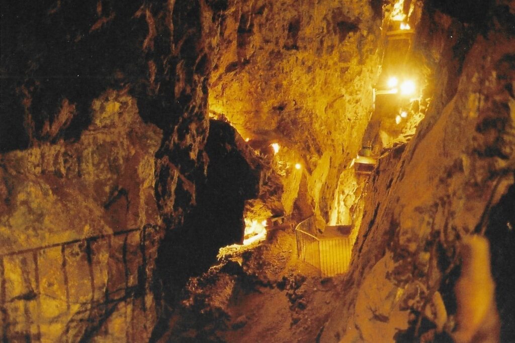 Looking down into an excavated copper mine in Zacatecas. Light bulbs give the cavernous brick work a golden glow.