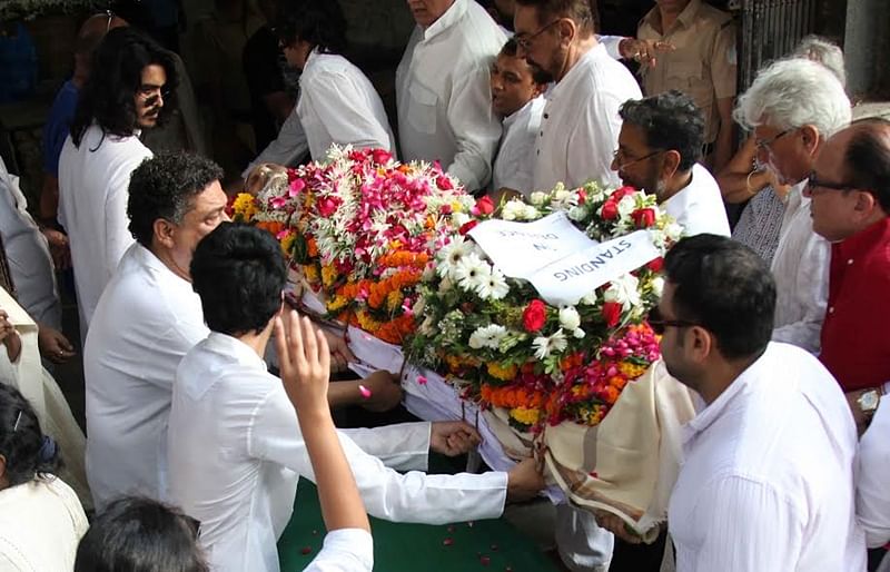 India Travel Writing: Mourners carry a garland shrouded body at a cremation in India