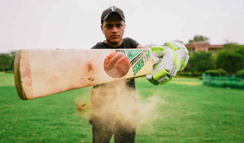 cricket player hitting ball
