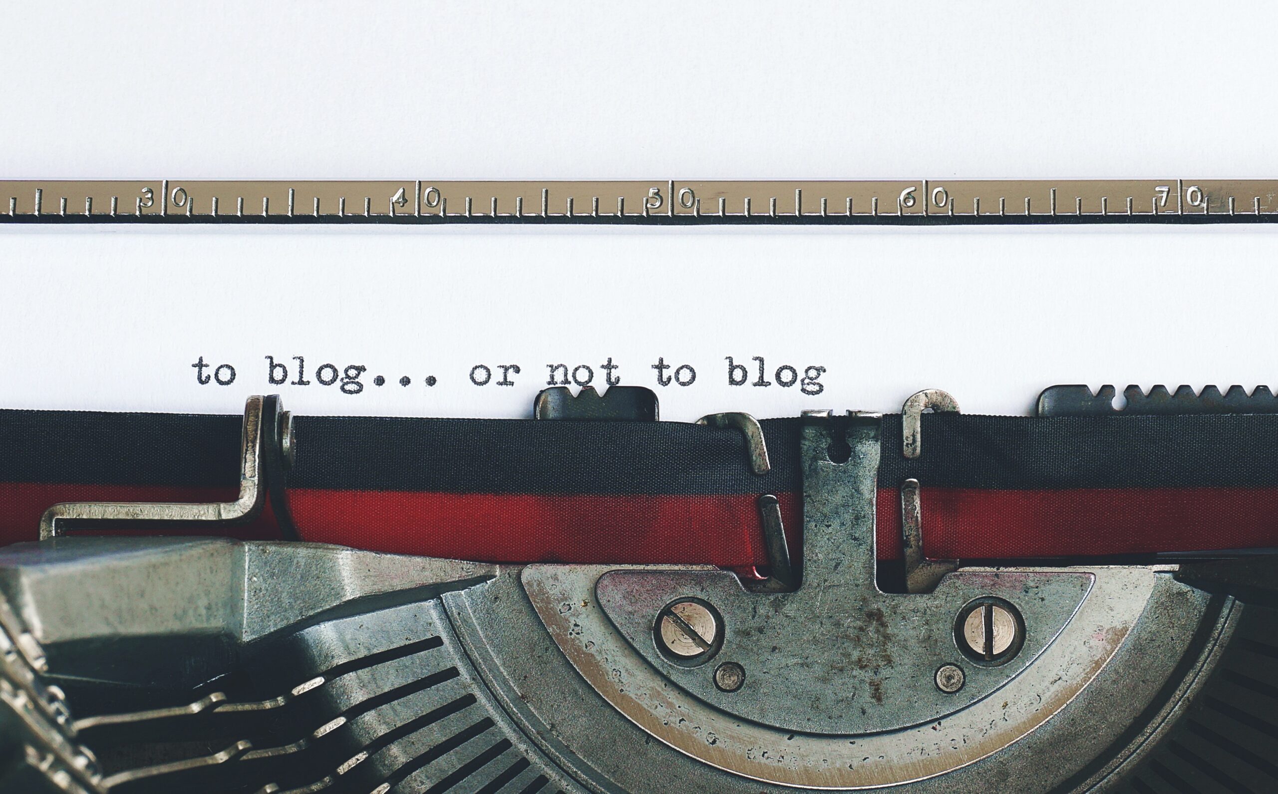 A sheet of paper in a type writer displays the phrase, 'To blog or not to blog'